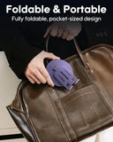 Purple foldable and portable item being placed into a brown leather bag.