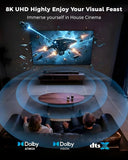 Living room setup with a large TV displaying a space-themed movie, featuring Dolby and DTS logos.