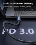 A braided black charging cable connected to a laptop, with text overlays reading 'Rapid 100W Power Delivery' and 'Ultra-Fast Charging & Data Transfer.' The cable has a visible 'FENUS' brand mark on its connector.
